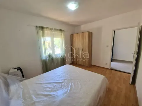 Furnished bedroom with a double bed, wardrobe, and window. - image 11