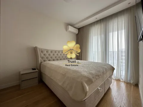 Bedroom with a double bed, nightstand, and a window with curtains. - image 8