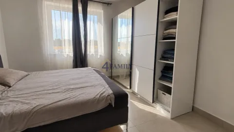 Bright bedroom with a double bed, large wardrobe, and a window. - image 4