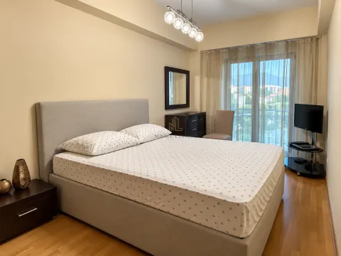 Spacious bedroom with a double bed, dresser, and access to the terrace. - image 8