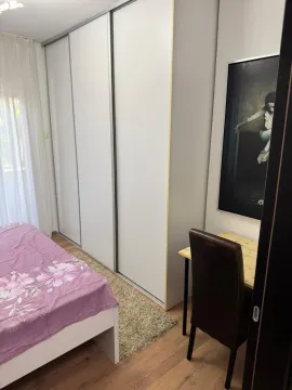 Bedroom with a bed, large wardrobe, and a desk. - image 9