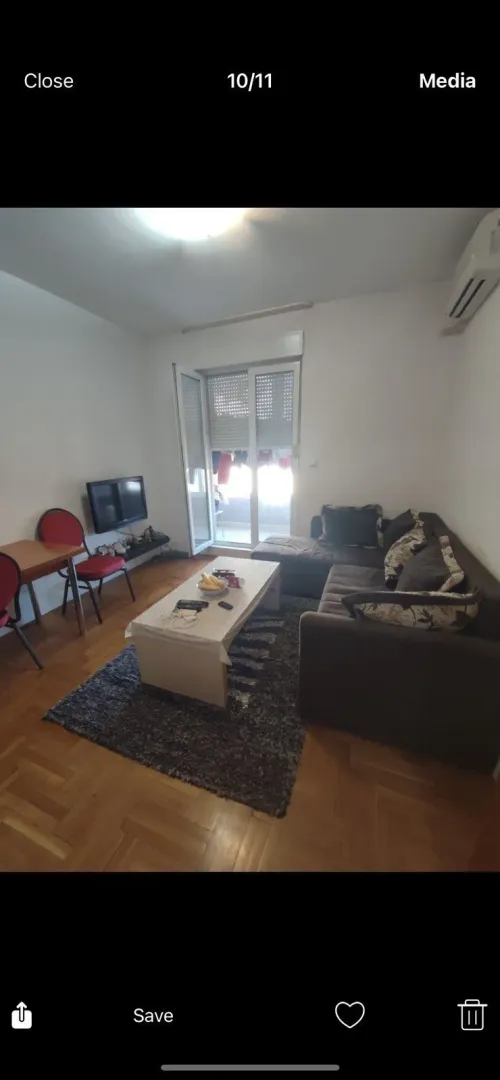 Living room with a sectional sofa and access to a balcony.