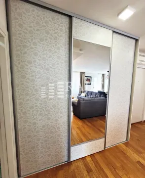 Large built-in wardrobe with a mirror in the bedroom. - image 13