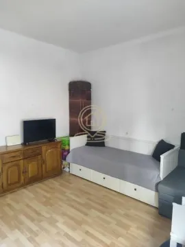 Smaller bedroom with a bed and a wooden chest of drawers. - image 2