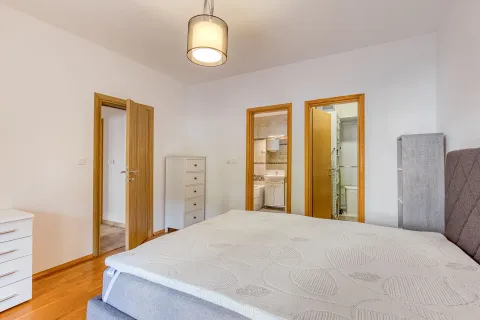 Bedroom with a double bed and a view of doors leading to the bathroom and other rooms. - image 10