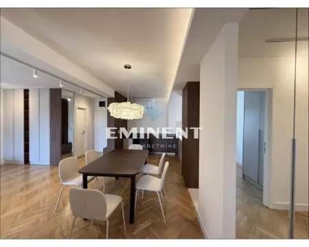 Dining area with a modern table and chairs within the living room. - image 4