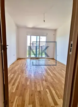Empty room with hardwood flooring and balcony doors. - image 2