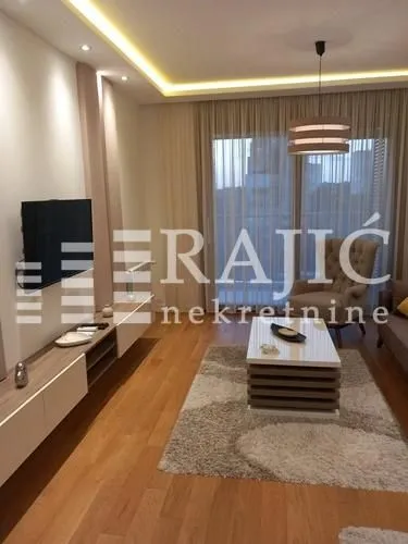 Modern and bright living room with furniture and TV.