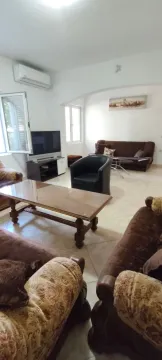 Spacious living room with seating set and television. - image 7