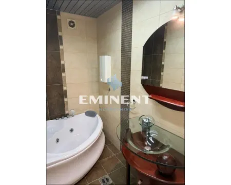 Bathroom equipped with a corner whirlpool bathtub and a sink. - image 13