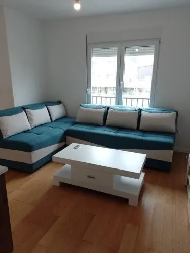 Living room with a blue and white corner sofa and a coffee table.
