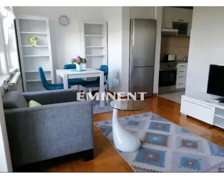 Living room with dining area and part of the kitchen in the background. - image 4