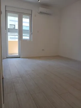 Empty, bright room with an air conditioner and balcony access. - image 3