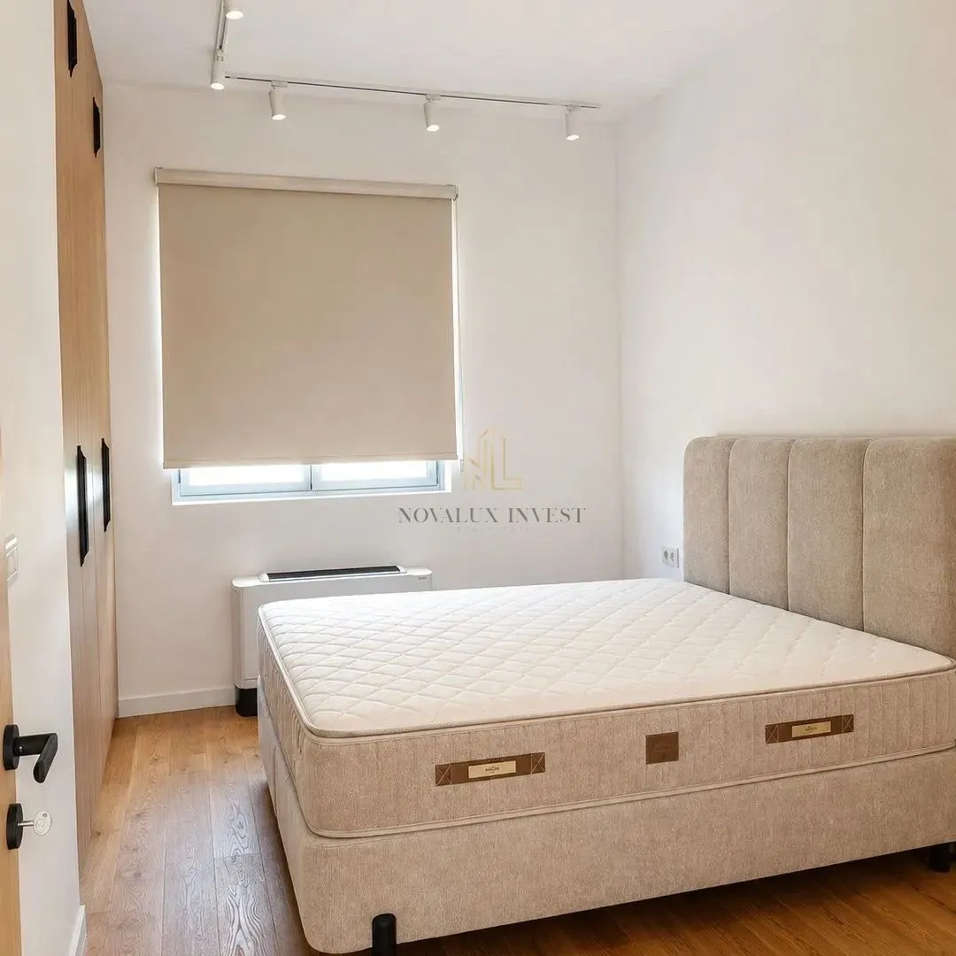 Bedroom with a double bed and a fitted wardrobe.