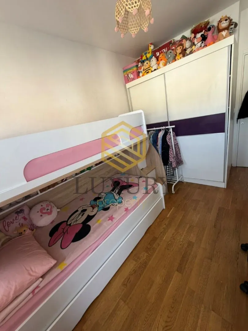Children's bedroom with a bunk bed and a large wardrobe.