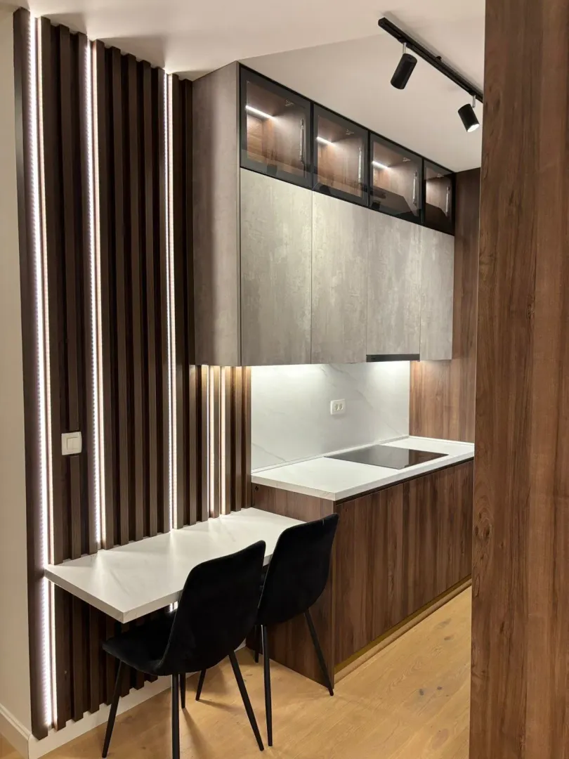 Modern kitchen with built-in cabinetry and a dining area.
