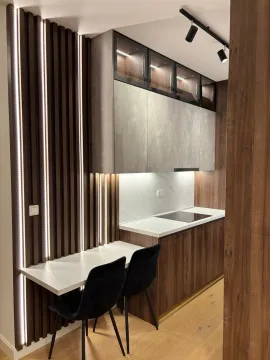 Modern kitchen with built-in cabinetry and a dining area. - image 5