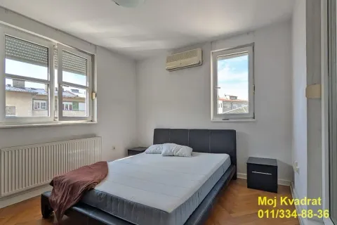 Bedroom with a double bed, nightstands, and an air conditioning unit. - image 6