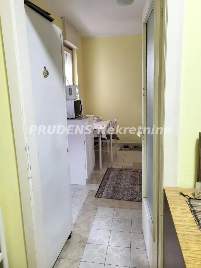 View from the hallway into the kitchen with a dining table.
