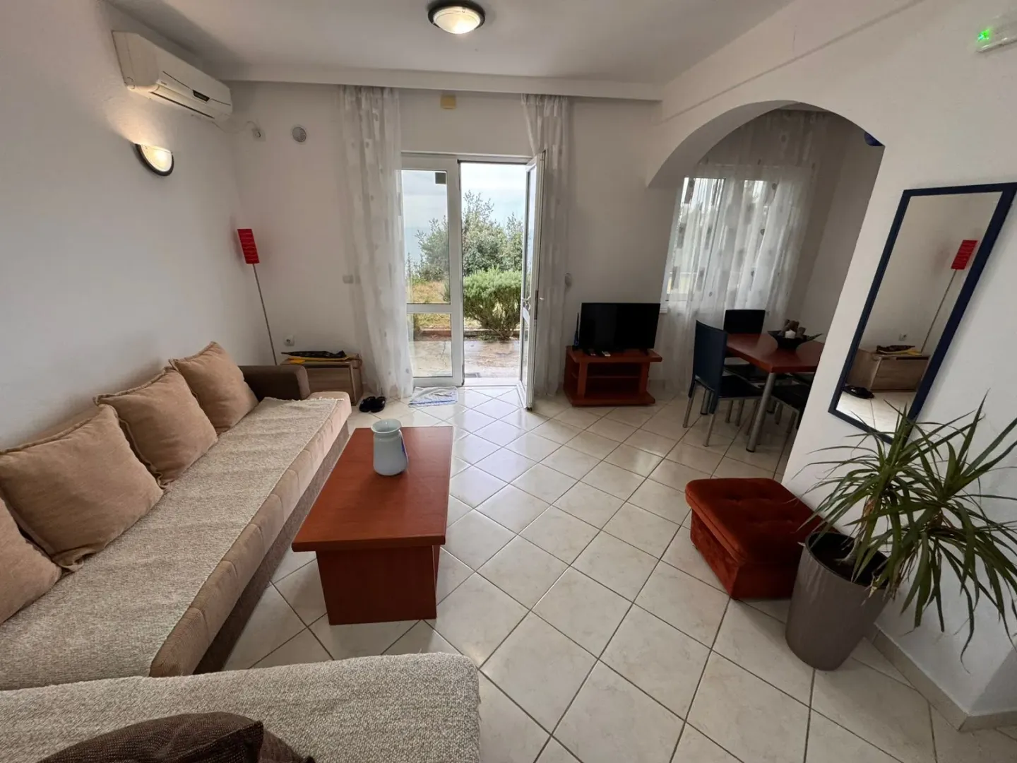Spacious living room with a sofa, coffee table, and access to the terrace.