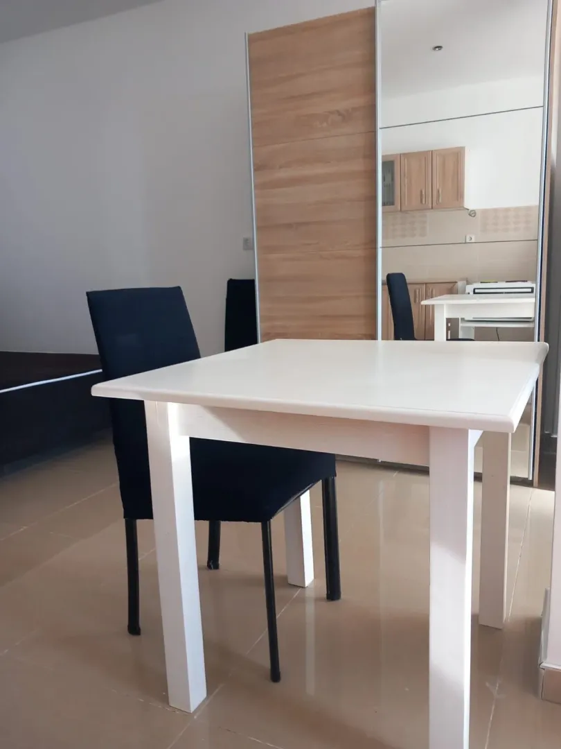 Small dining table with chairs in the living room.