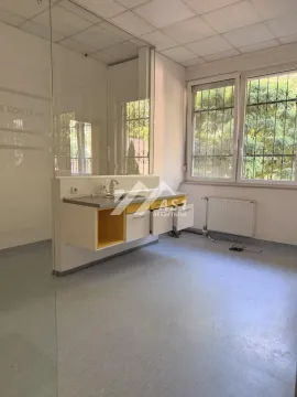 Empty kitchen with a sink and built-in units in an office space. - image 12