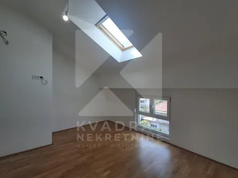 Empty attic room with parquet flooring and a skylight. - image 14