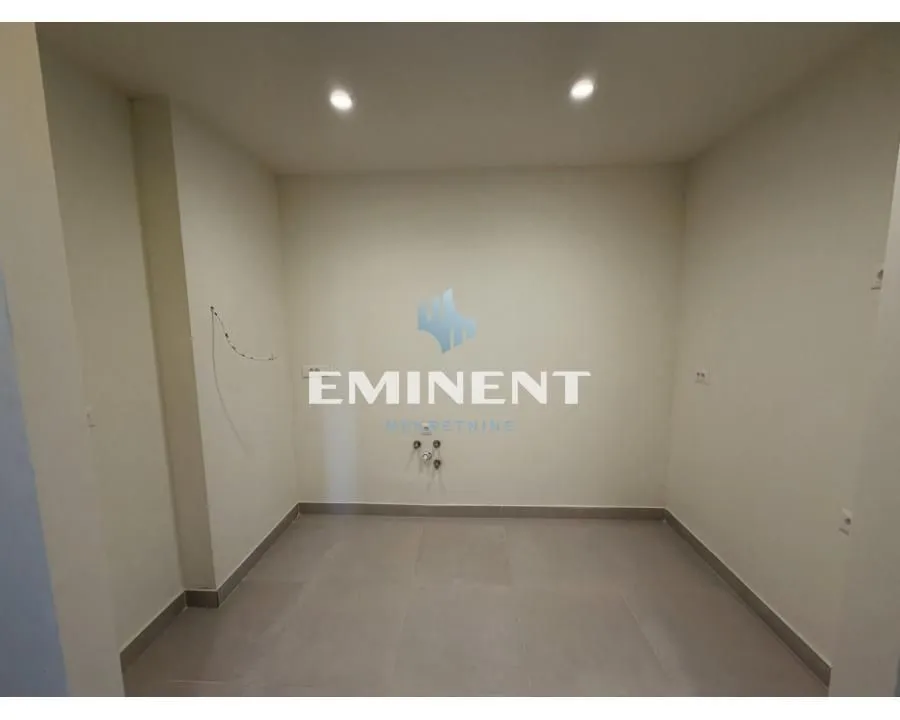 Empty room with tiled flooring and prepared utility connections.