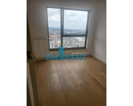 Empty room with wooden flooring and a large window overlooking the city. - image 5