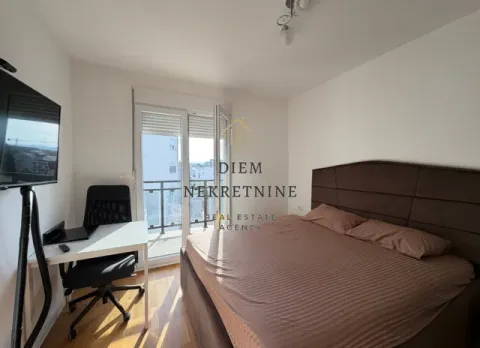 Furnished bedroom with a double bed, desk, and access to the terrace. - image 7