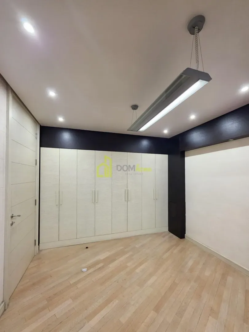 Empty bedroom with a fitted wardrobe and hardwood flooring.