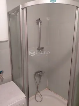 Bathroom with a tiled shower cabin. - image 5