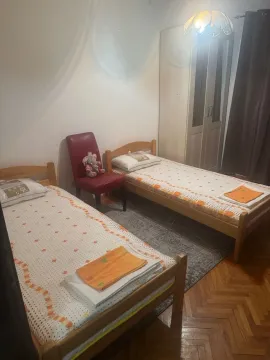 A bedroom with two wooden beds and a wardrobe. - image 11