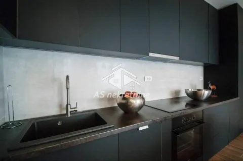Modern kitchen with dark cabinetry, built-in oven, and a sink. - image 5