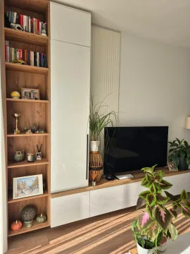 Living room with a built-in wardrobe, bookshelf and television. - image 12