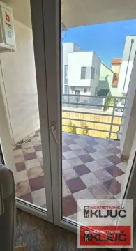 View of a tiled balcony with a railing through an open balcony door. - image 35