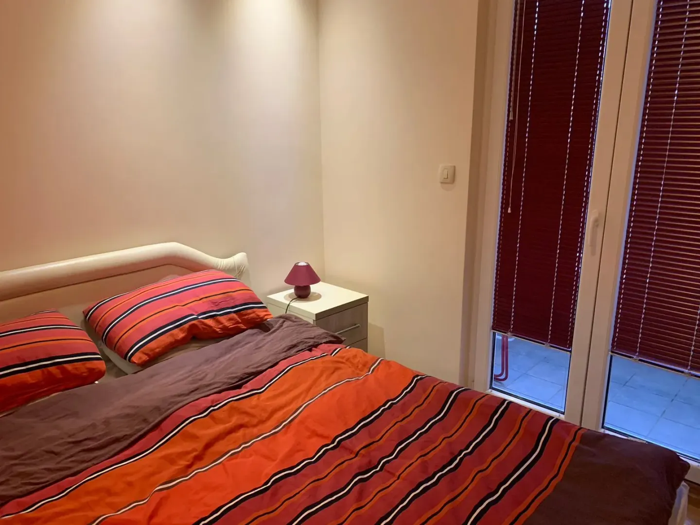 Smaller bedroom with a double bed and access to the terrace.