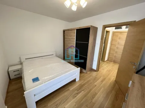 Furnished bedroom with a double bed, wardrobe, and wooden flooring. - image 8