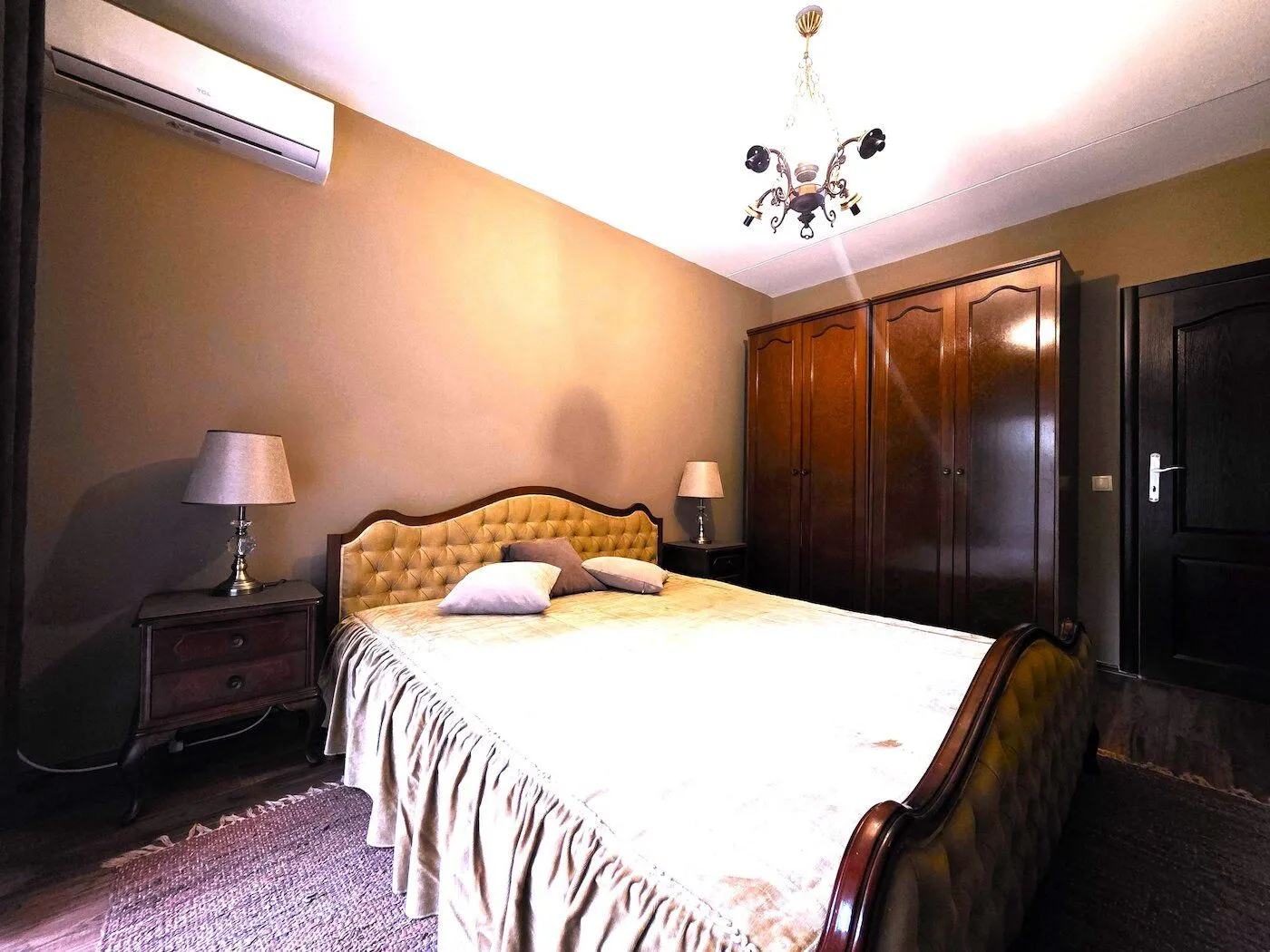 Furnished bedroom with a double bed, wardrobe, and nightstands.