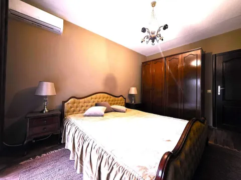 Furnished bedroom with a double bed, wardrobe, and nightstands. - image 14