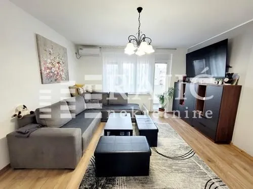 Spacious living room with a sofa and TV.