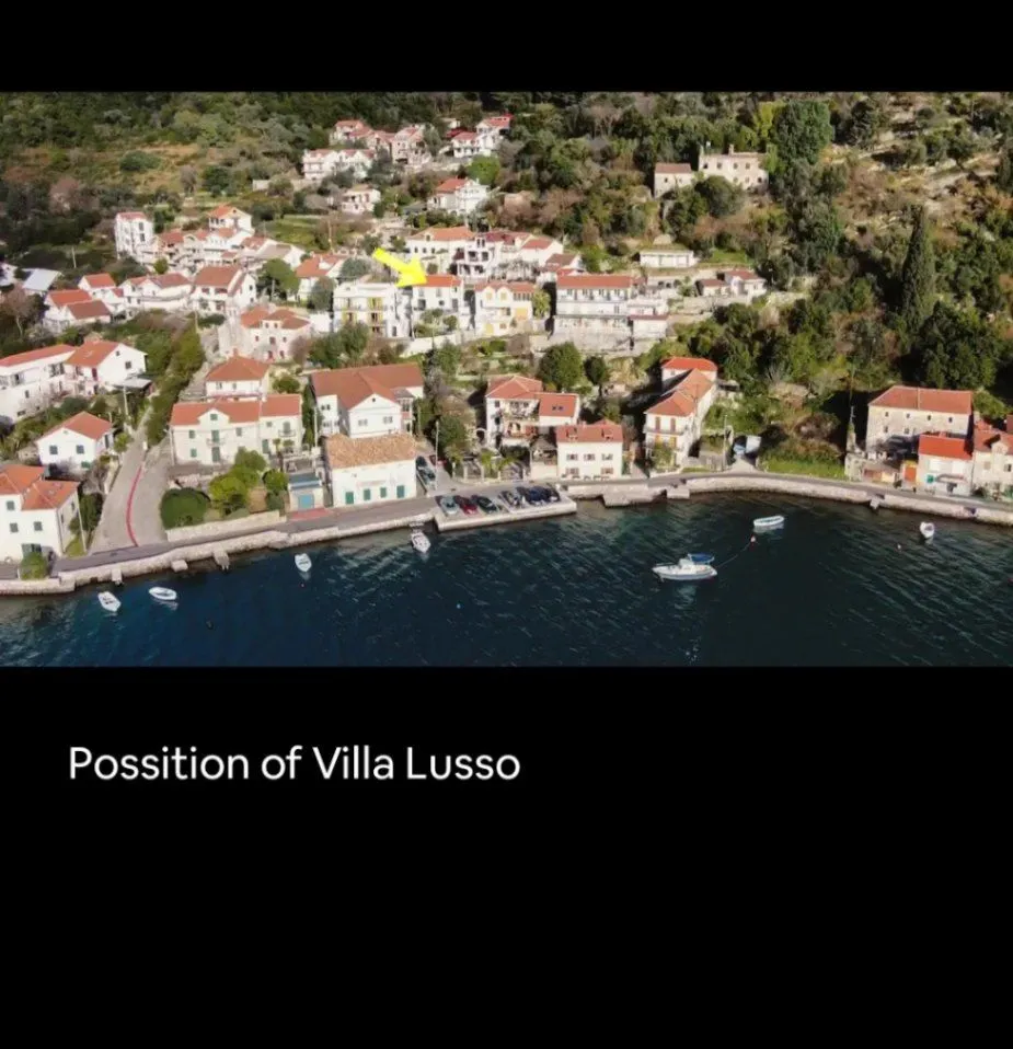 Aerial view of a coastal settlement with a nearby shoreline and sea.