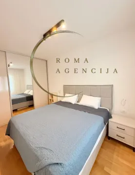 Modern bedroom with a double bed, wardrobe, and a nightstand. - image 7