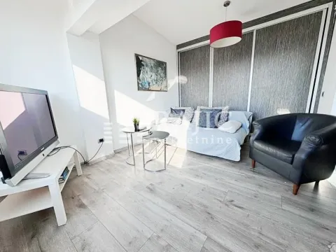 Living room with a sofa set, television, and small tables. - image 2