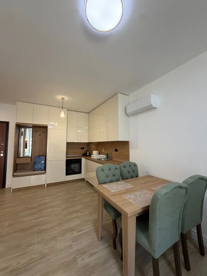 Modern kitchen with dining area and built-in appliances.