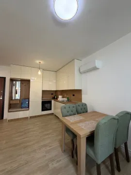 Modern kitchen with dining area and built-in appliances. - image 4