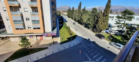 View from the terrace overlooking the building, street, and surrounding greenery. - image 10