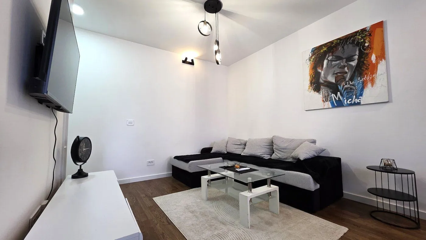 Living room with a sectional sofa, coffee table and TV.