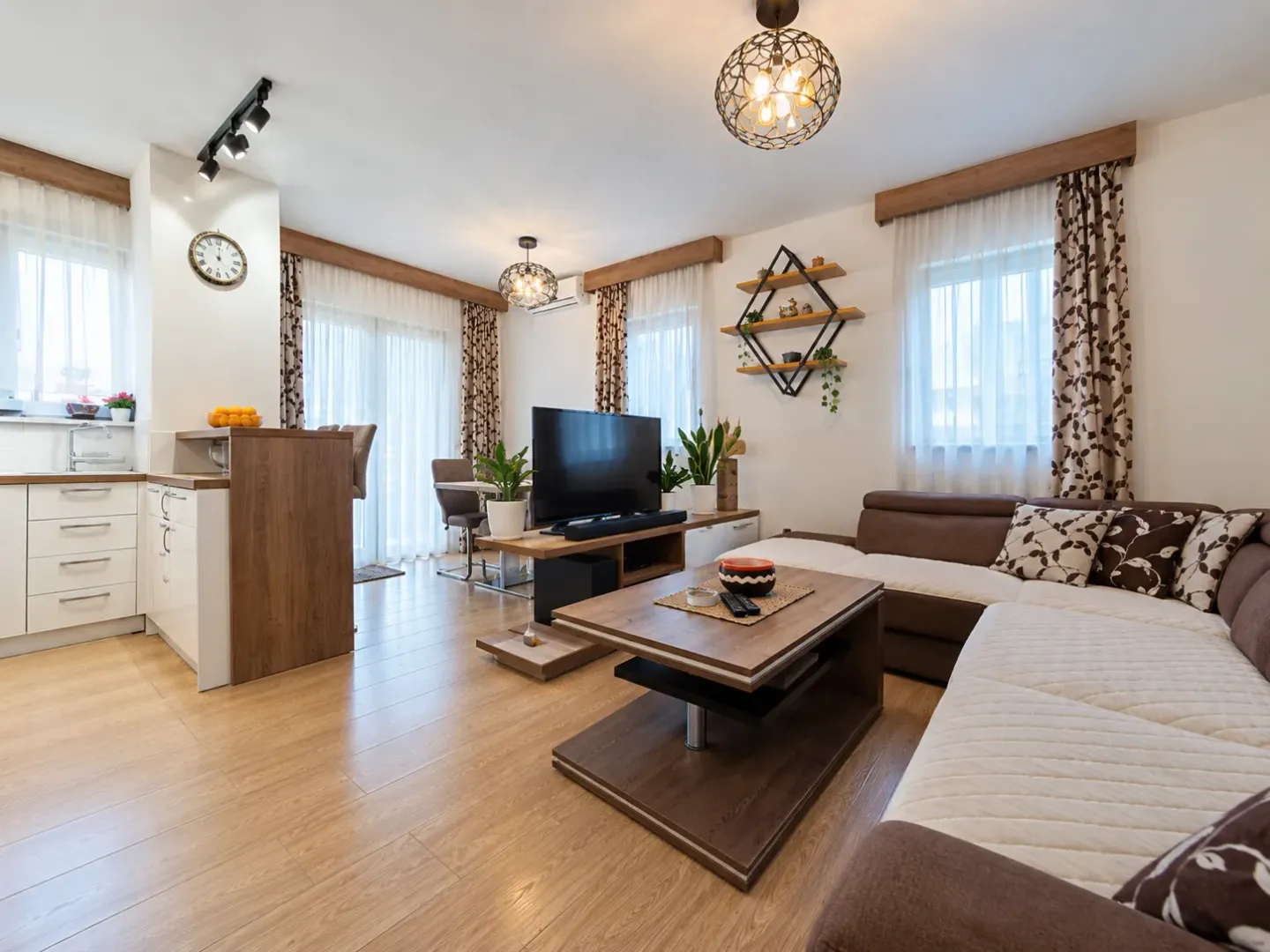 Modern living room with a sectional sofa and an adjoining dining area.