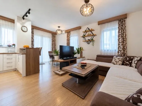 Modern living room with a sectional sofa and an adjoining dining area. - image 10